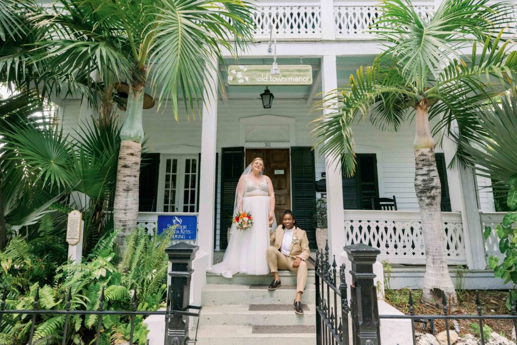 Brides posing in front of their key west wedding venue, Old Town manor