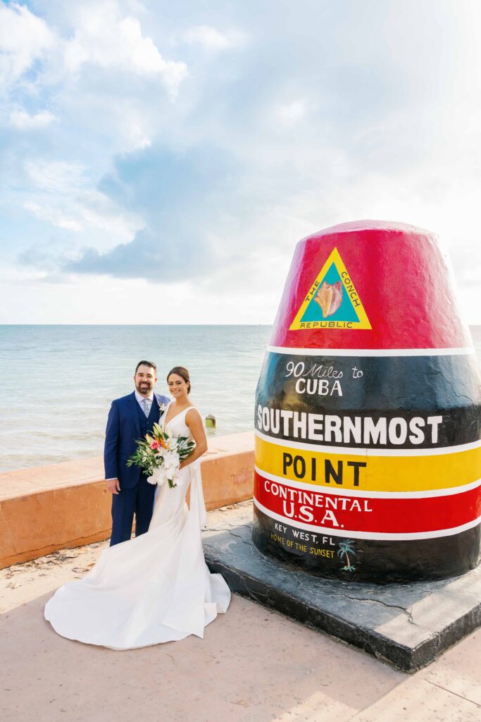 Bride and groom posing in front of the Key West '90 miles to cuba' sign