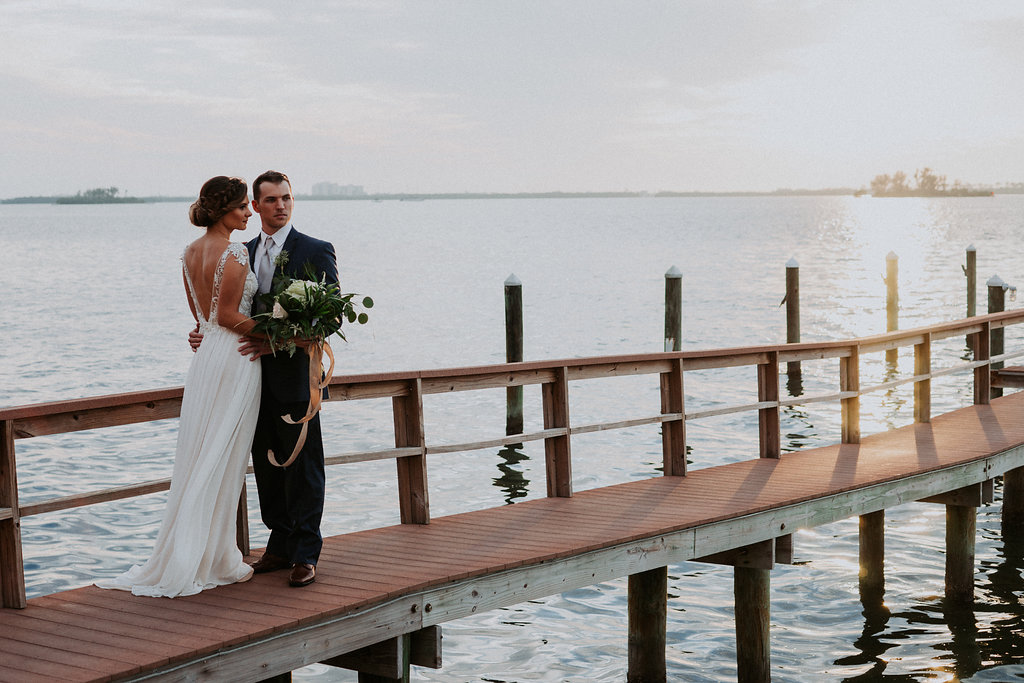 A bride and groom on the pier of their Tampa wedding venue