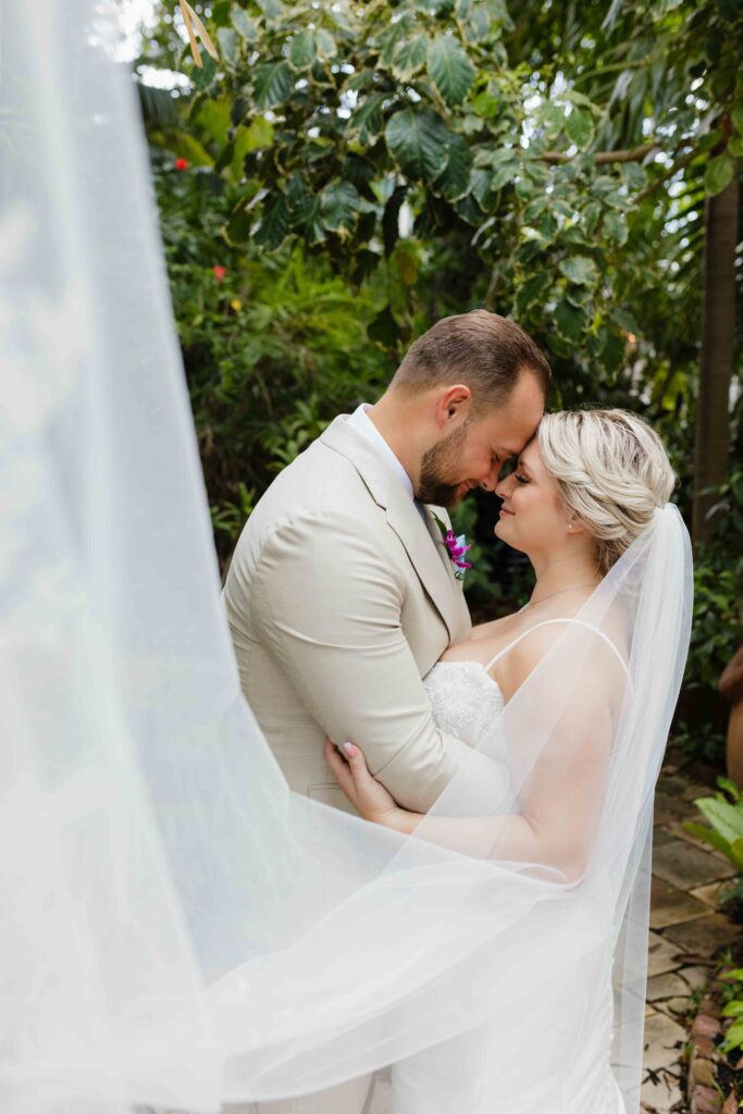 A bride and groom embrace at The Garden Hotel in Key West, Florida