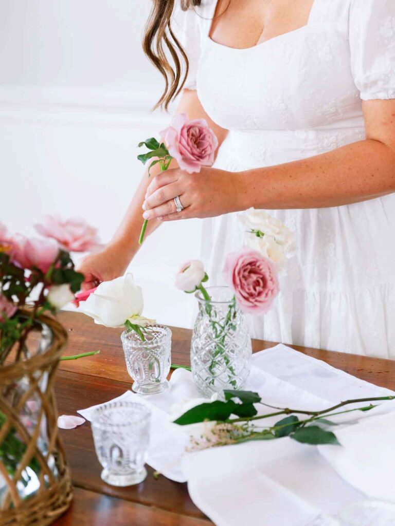A wedding planner setting up decor at a wedding