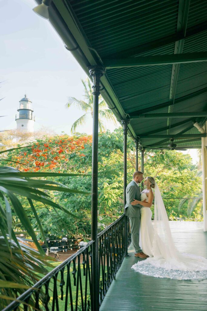 A bride and groom on the balcony of The Ernest Hemingway Home.