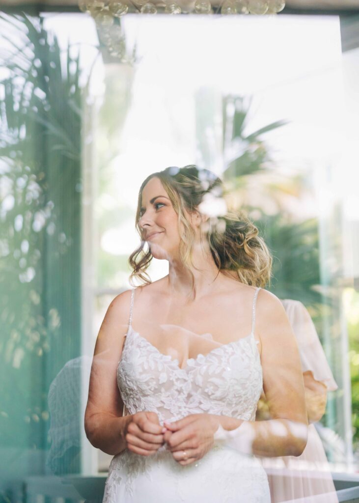 A bride looking through a window on her wedding day in Key West.