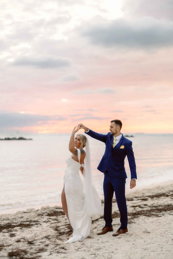A bride and groom dance on the beach in Key West