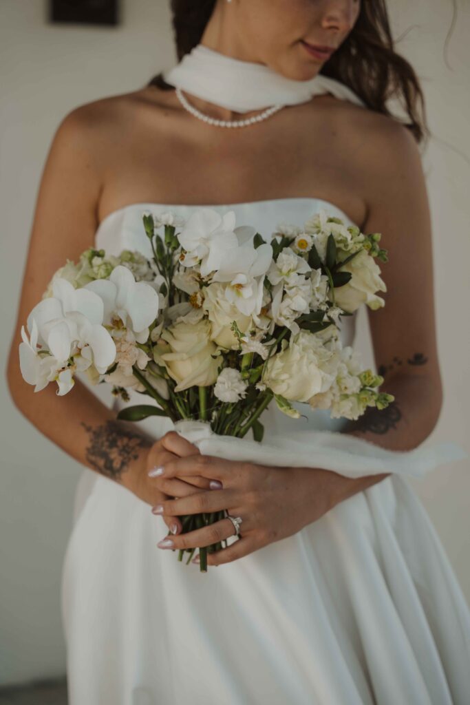 A bride holding her bouquet at her Hotel Zamora wedding