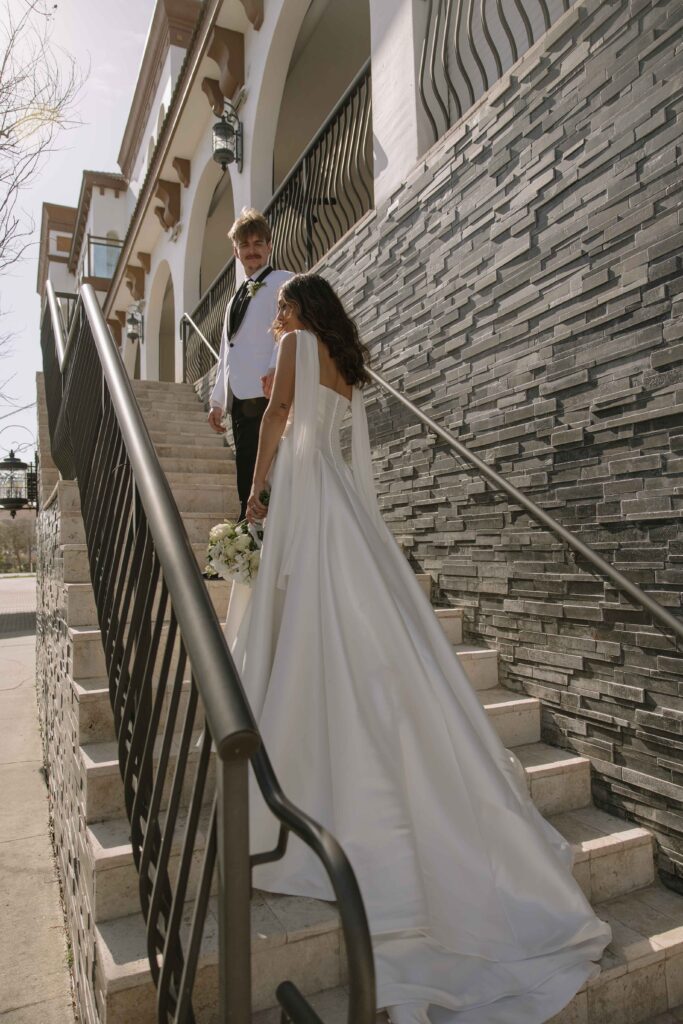 Bride and groom on the outside stairs of Hotel Zamora 