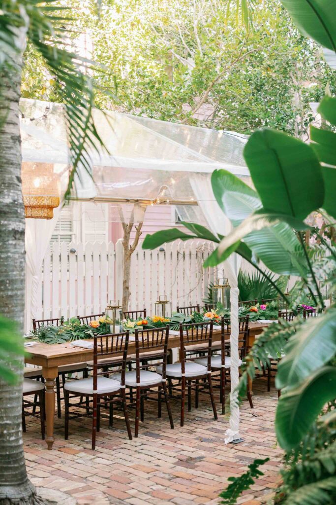 A long table set up with tropical decor at Old Town Manor in Key West